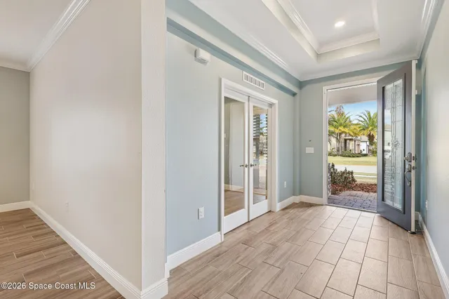 a view of an entryway with wooden floor