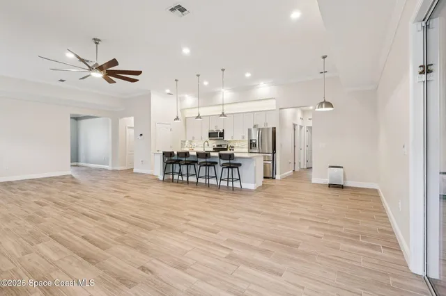 a big room with wooden floor and windows