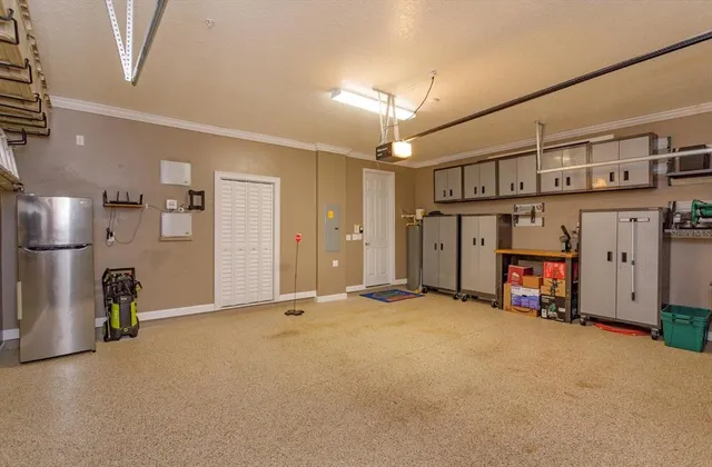 an empty room with windows and ceiling fan