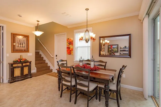 a dining room with furniture and window