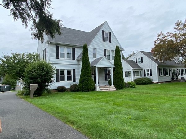 18 Maple Road Longmeadow, MA 01106 - Photo 1 of 26 a front view of a house with a yard and trees