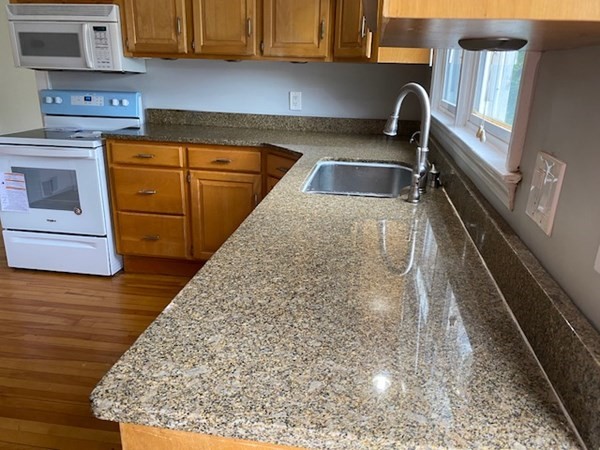 18 Maple Road Longmeadow, MA 01106 - Photo 4 of 26 a kitchen with wooden cabinets and sink