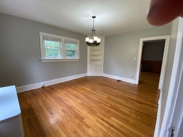 18 Maple Road Longmeadow, MA 01106 - Photo 7 of 26 wooden floor in an empty room with a window