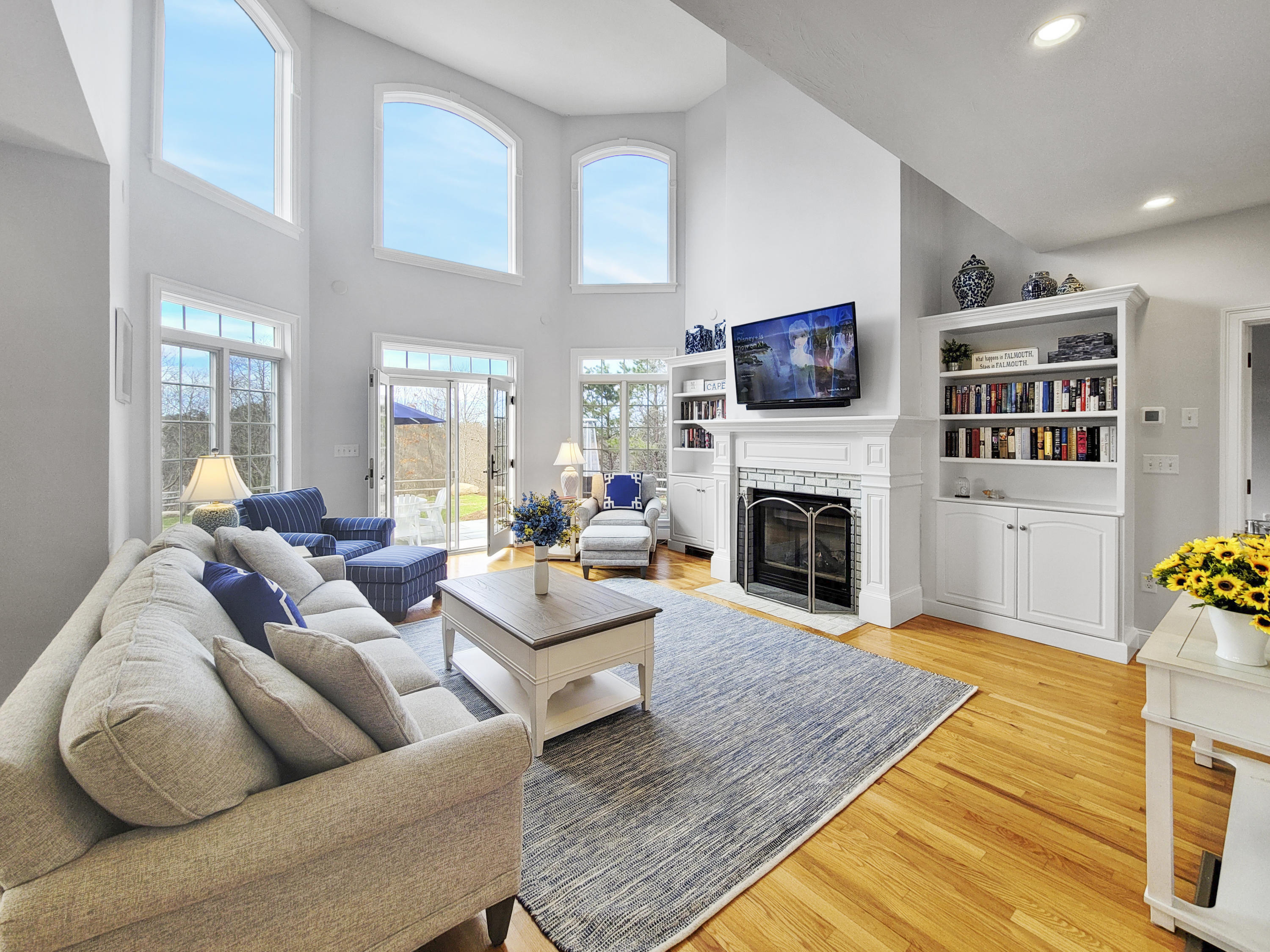 215 Cairn Ridge Road East Falmouth, MA 02536 - Photo 17 of 60 a living room with furniture a flat screen tv and a fireplace
