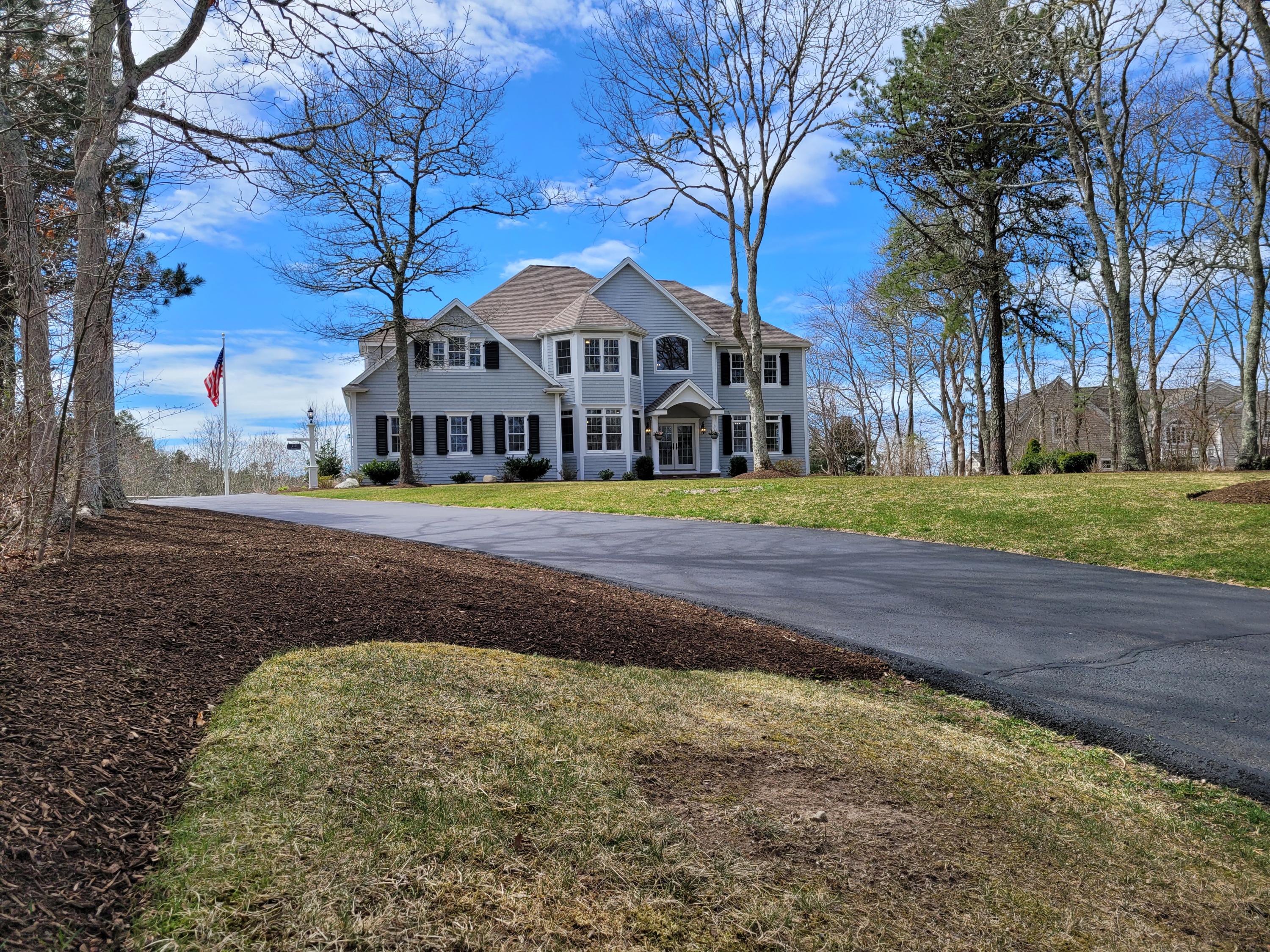 215 Cairn Ridge Road East Falmouth, MA 02536 - Photo 2 of 60 a view of a big house with a big yard and large trees