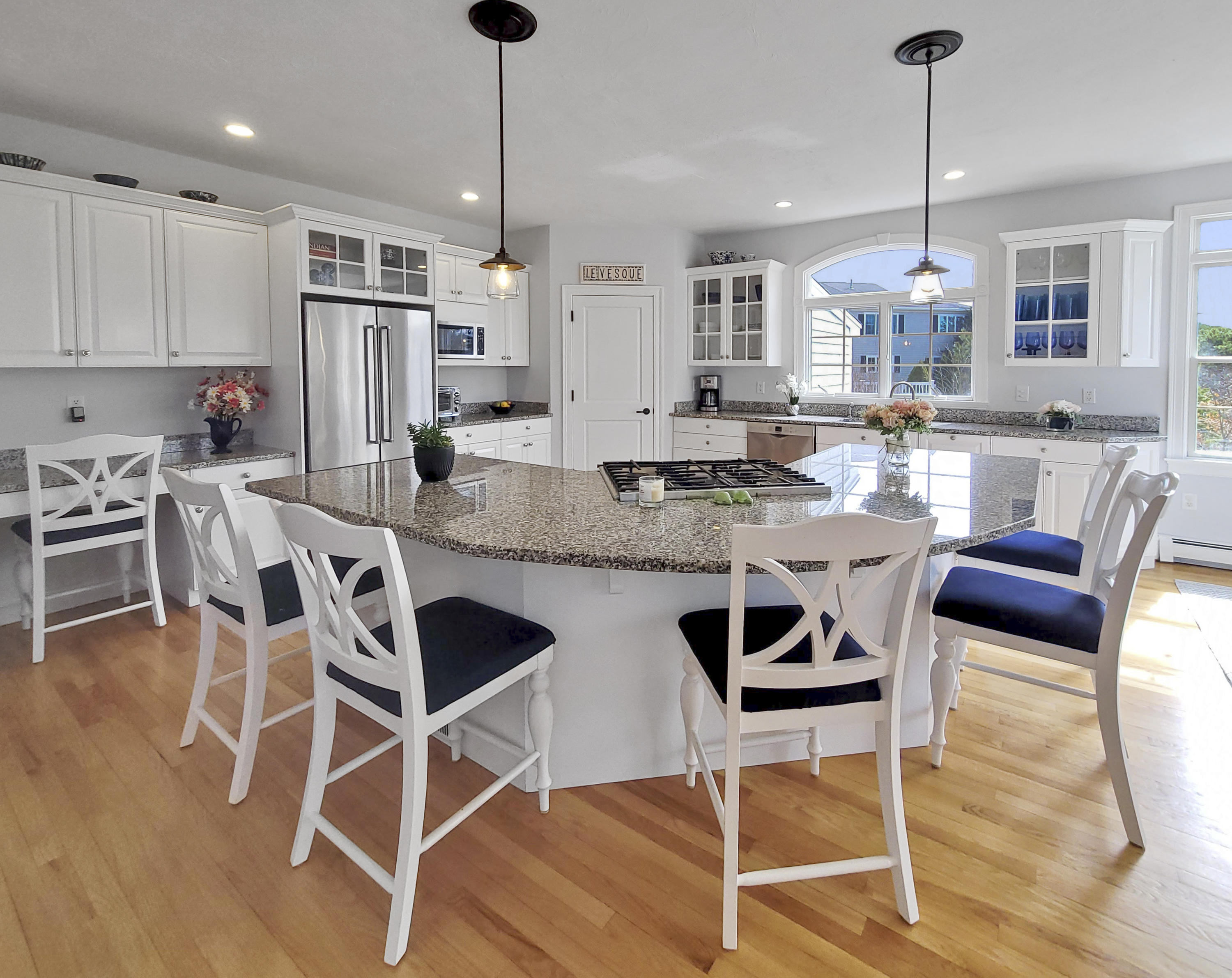 215 Cairn Ridge Road East Falmouth, MA 02536 - Photo 21 of 60 a kitchen with stainless steel appliances kitchen island granite countertop a dining table chairs stove refrigerator and cabinets