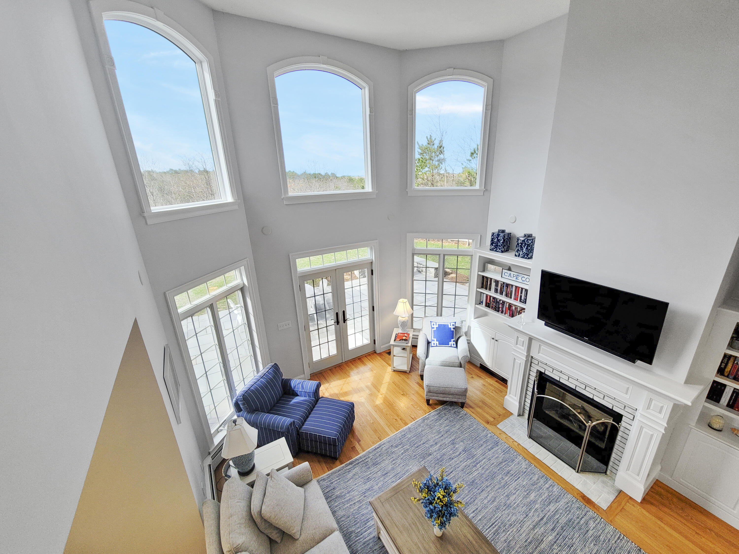 215 Cairn Ridge Road East Falmouth, MA 02536 - Photo 29 of 60 a living room with furniture a flat screen tv and a fireplace