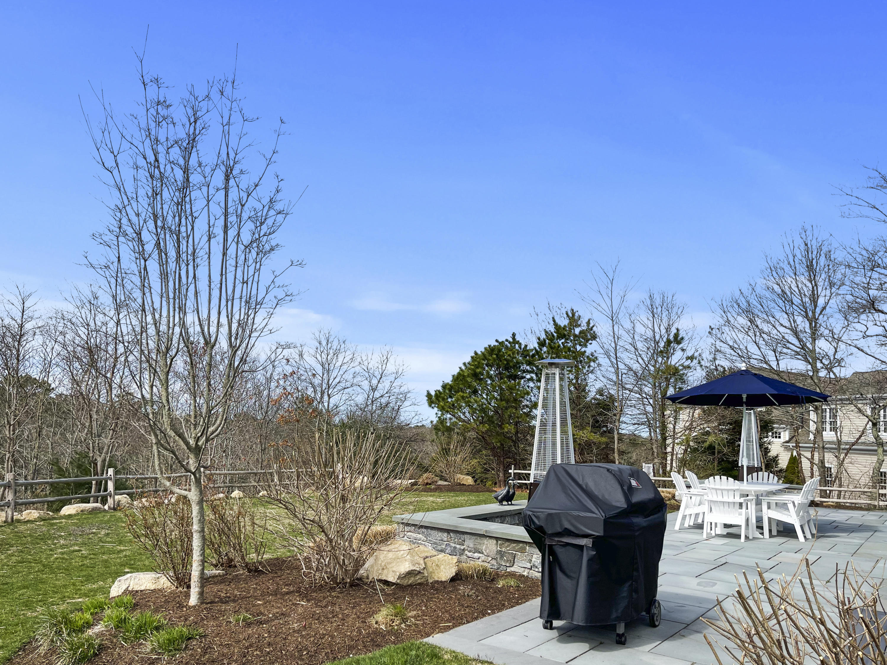 215 Cairn Ridge Road East Falmouth, MA 02536 - Photo 48 of 60 a view of patio with table and chairs under an umbrella