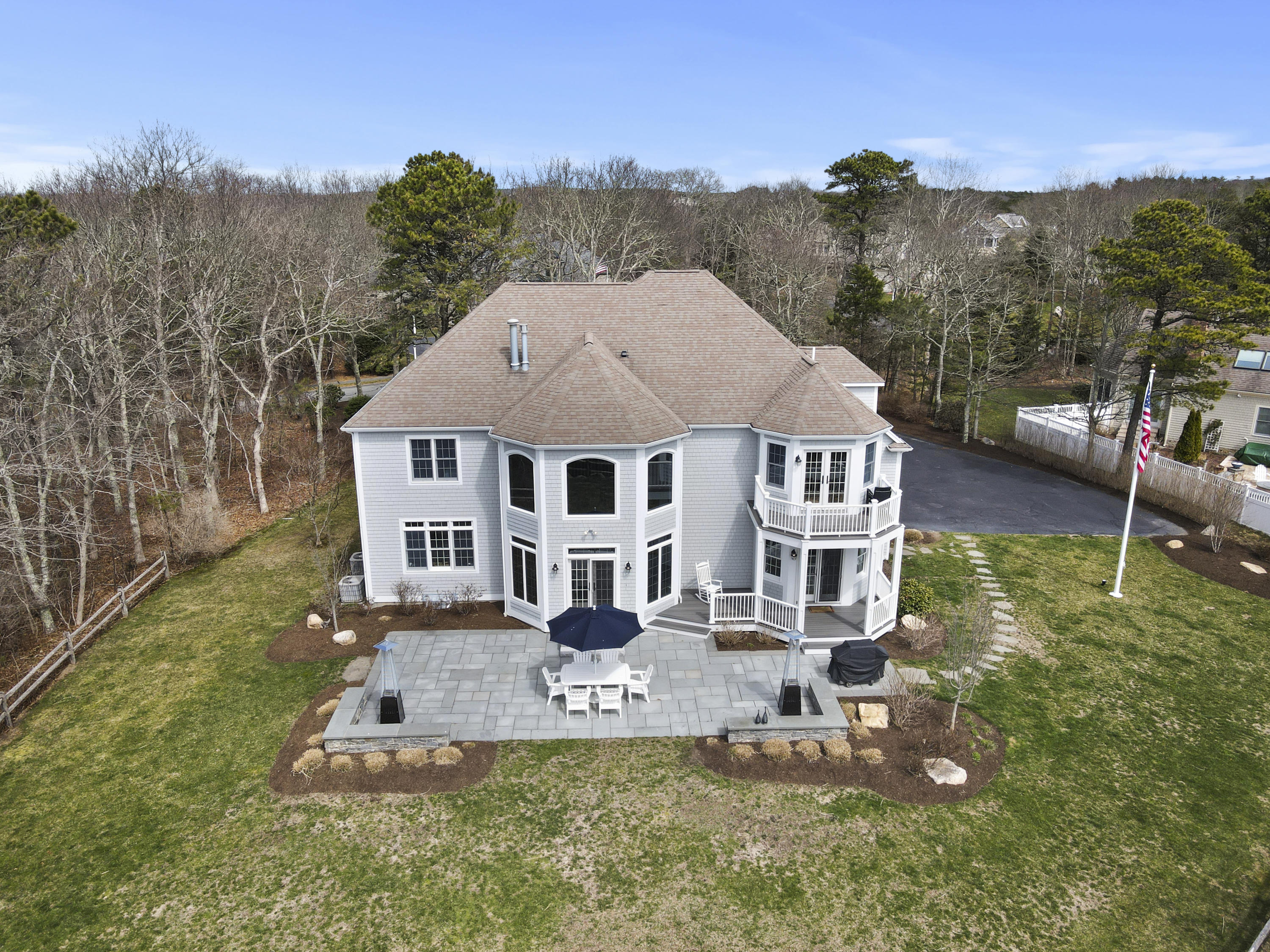 215 Cairn Ridge Road East Falmouth, MA 02536 - Photo 55 of 60 a aerial view of a house with a yard table and chairs