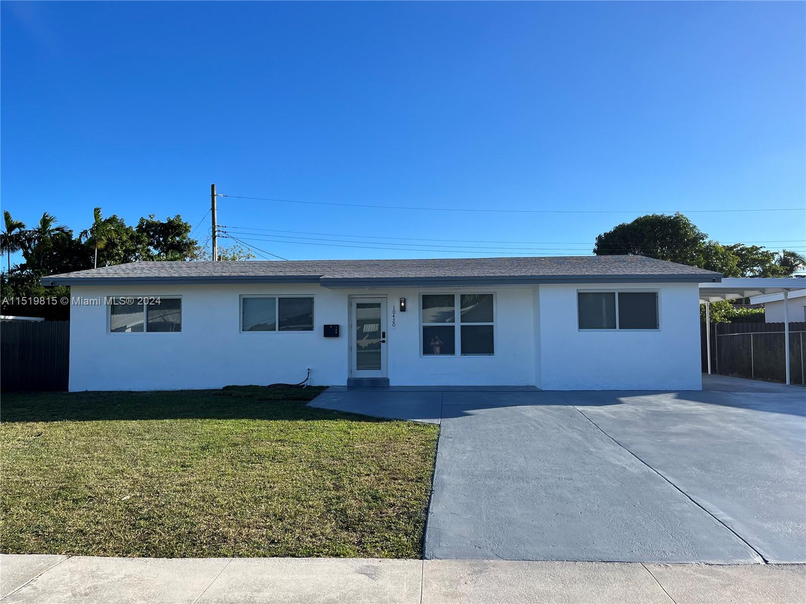 10420 Southwest 42nd Street Miami, FL 33165 - Photo 1 of 17 a front view of a house with a yard
