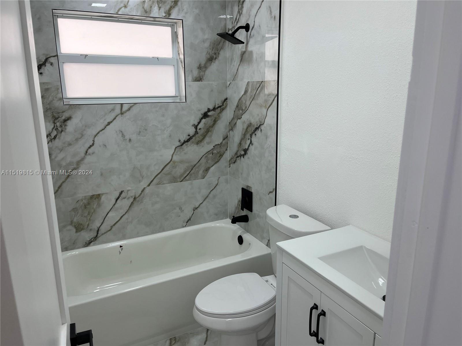 10420 Southwest 42nd Street Miami, FL 33165 - Photo 13 of 17 a bathroom with a sink a toilet and a bathtub