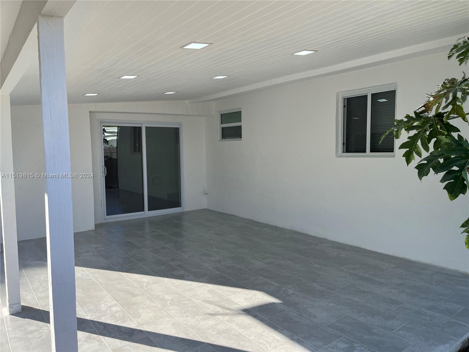 10420 Southwest 42nd Street Miami, FL 33165 - Photo 14 of 17 wooden floor in an empty room with a window