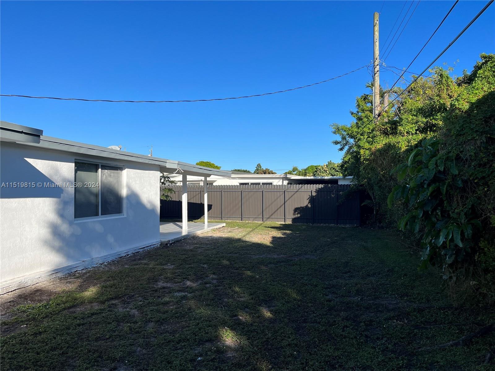 10420 Southwest 42nd Street Miami, FL 33165 - Photo 17 of 17 a backyard of a house with table and chairs