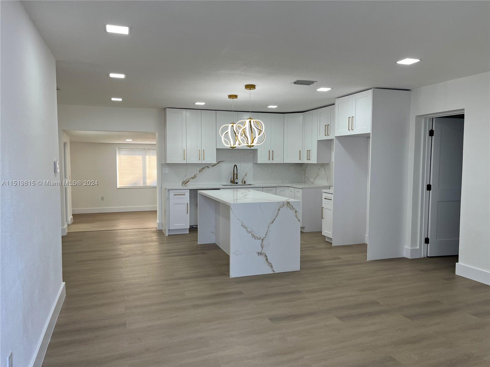 10420 Southwest 42nd Street Miami, FL 33165 - Photo 3 of 17 a large kitchen with stainless steel appliances granite countertop a large counter top a sink and a refrigerator
