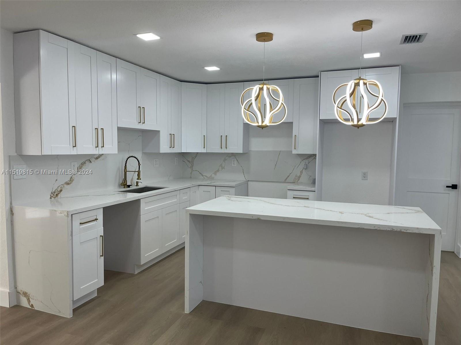 10420 Southwest 42nd Street Miami, FL 33165 - Photo 4 of 17 a kitchen with kitchen island granite countertop a sink and dishwasher