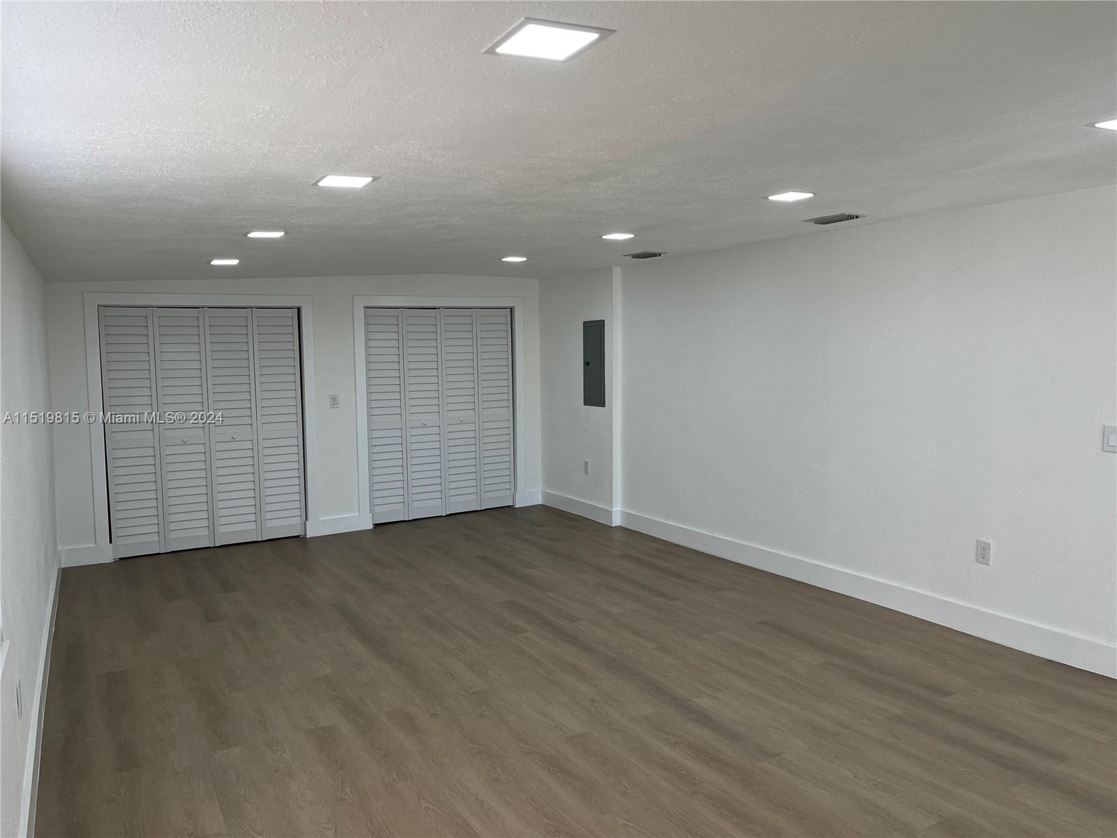 10420 Southwest 42nd Street Miami, FL 33165 - Photo 6 of 17 an empty room with wooden floor and windows