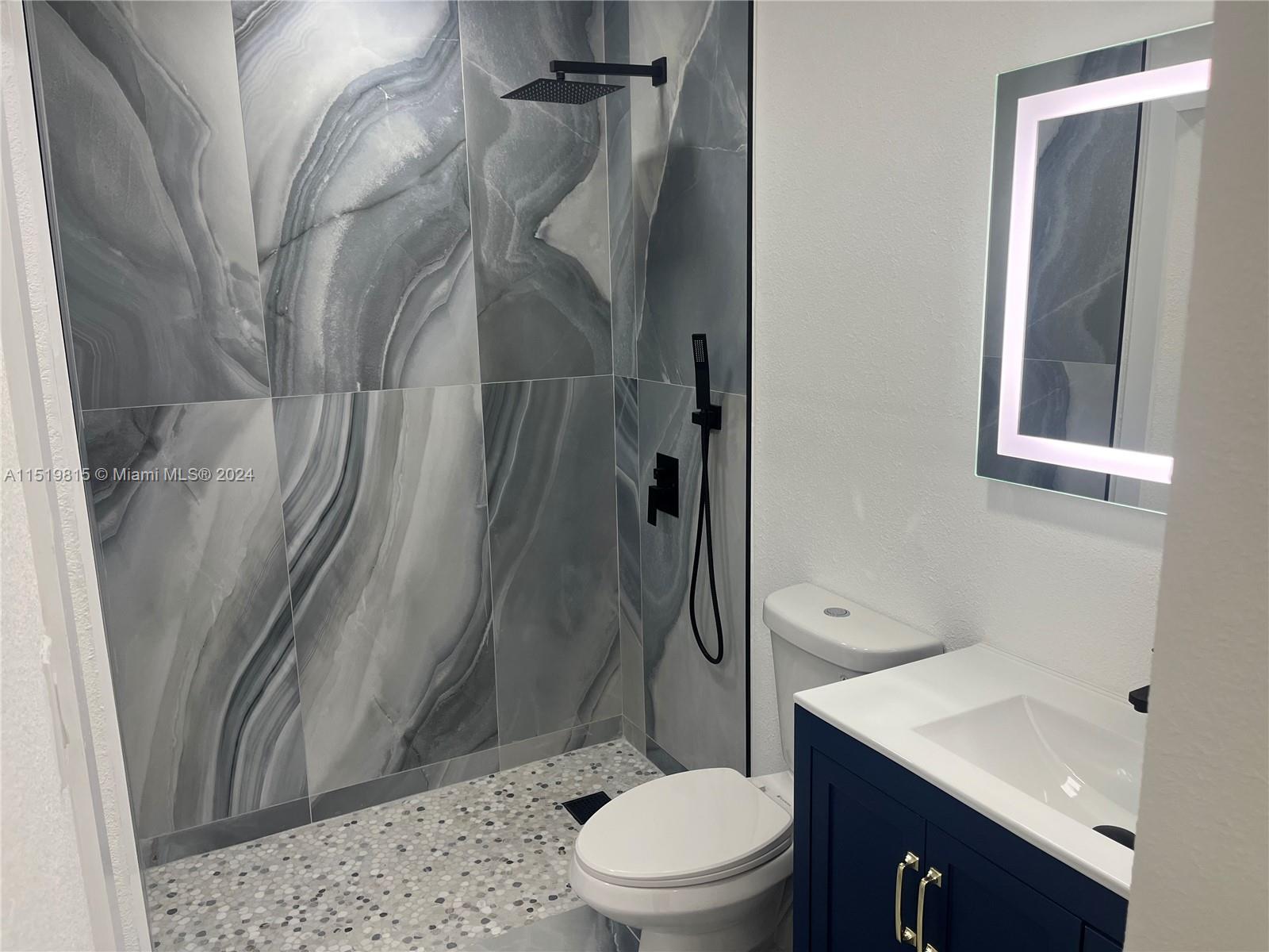 10420 Southwest 42nd Street Miami, FL 33165 - Photo 8 of 17 a bathroom with a sink toilet and shower