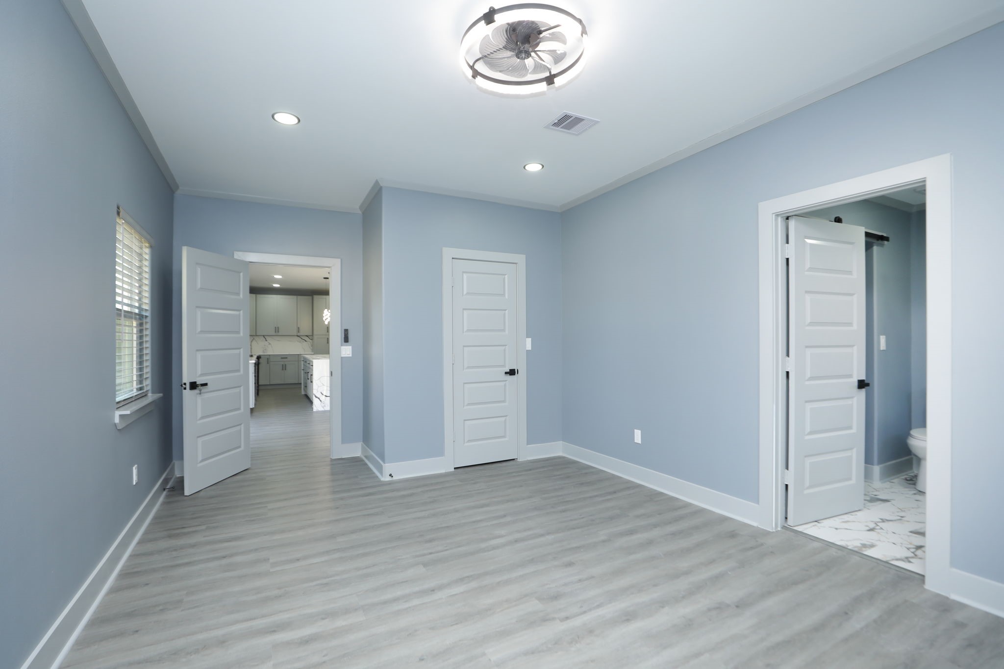 4047 Juliet Street Houston, TX 77087 - Photo 22 of 38 wooden floor in an empty room with a kitchen