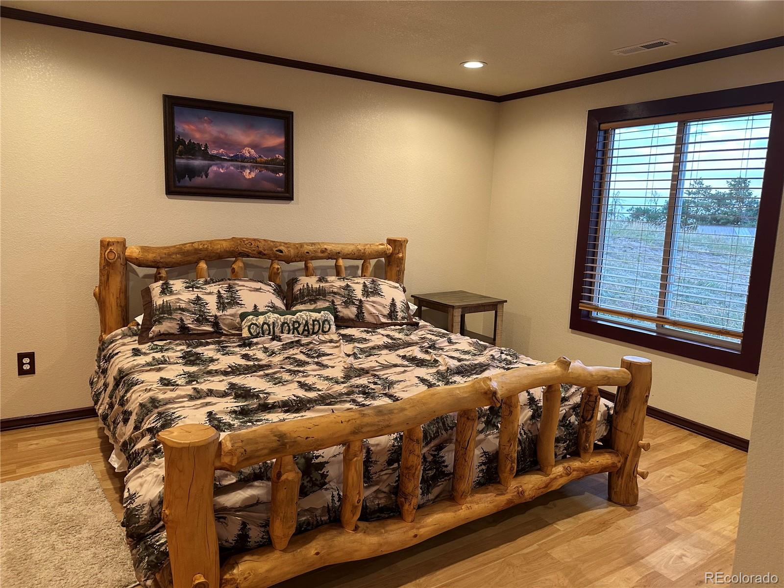 1080 South Dutch Valley Road Bennett, CO 80102 - Photo 14 of 18 a bedroom with a bed next to a window