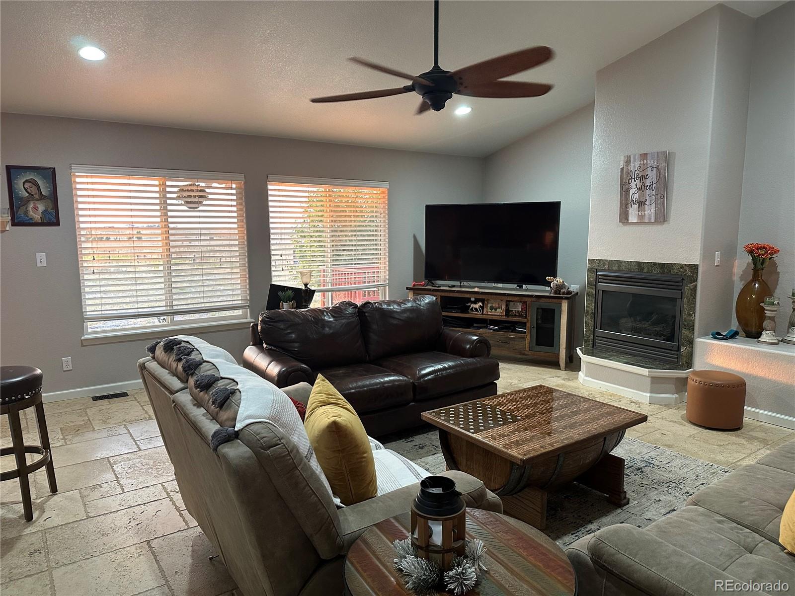 1080 South Dutch Valley Road Bennett, CO 80102 - Photo 2 of 18 a living room with furniture a flat screen tv and a window
