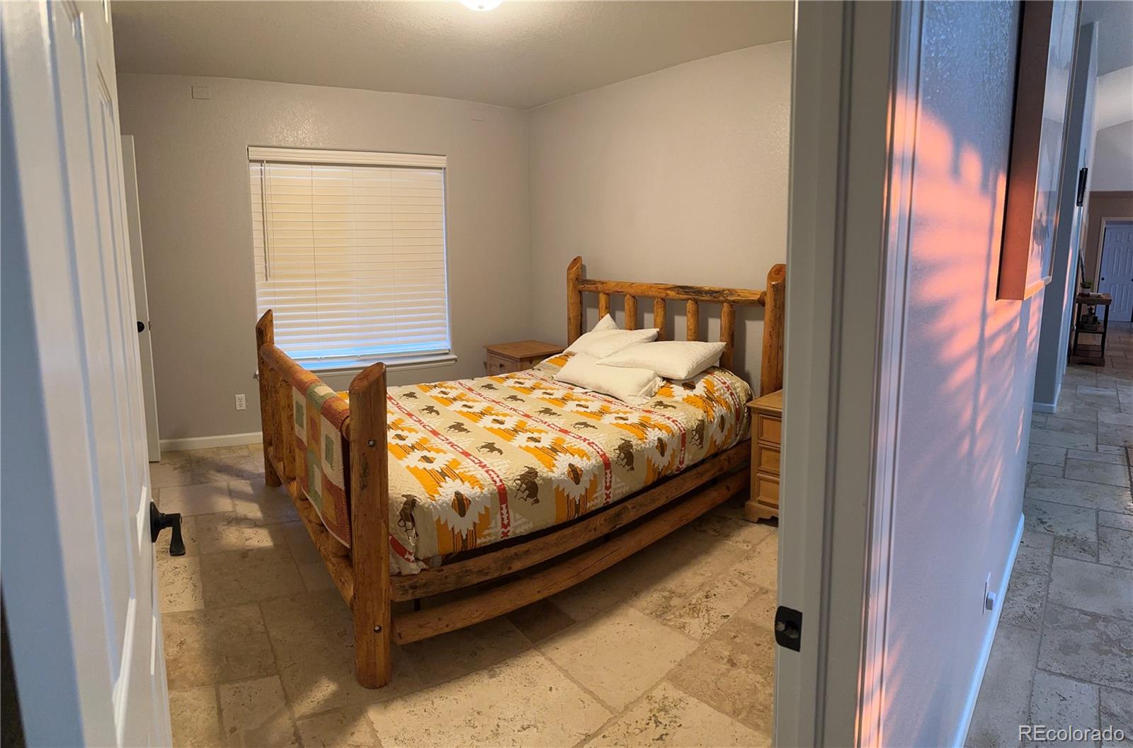 1080 South Dutch Valley Road Bennett, CO 80102 - Photo 4 of 18 a bedroom with a bed and a window