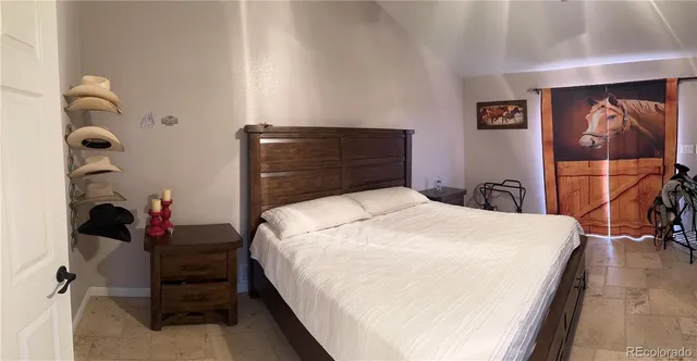 a bathroom with a granite countertop sink and a toilet