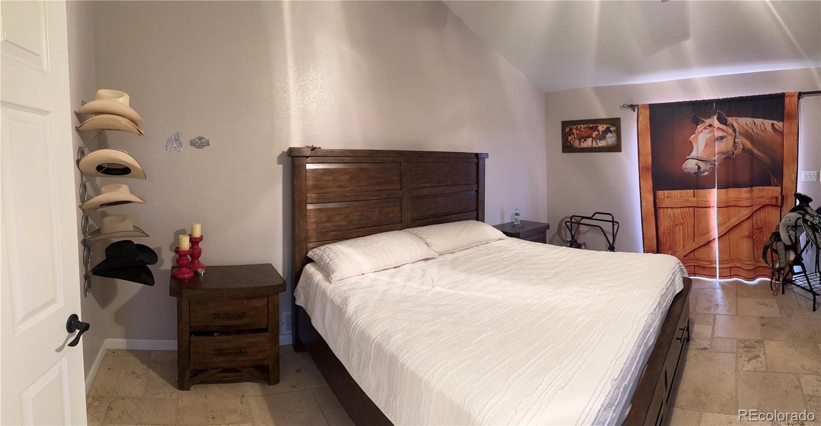 1080 South Dutch Valley Road Bennett, CO 80102 - Photo 7 of 18 a bedroom with a bed and a mirror