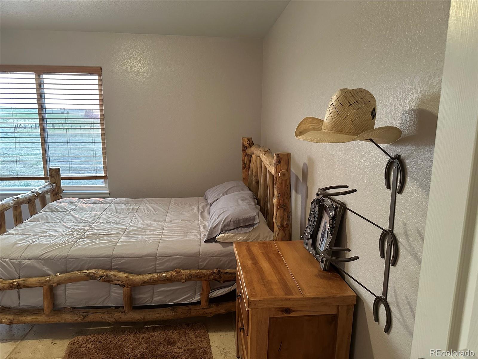 1080 South Dutch Valley Road Bennett, CO 80102 - Photo 10 of 18 a bedroom with a bed and a window