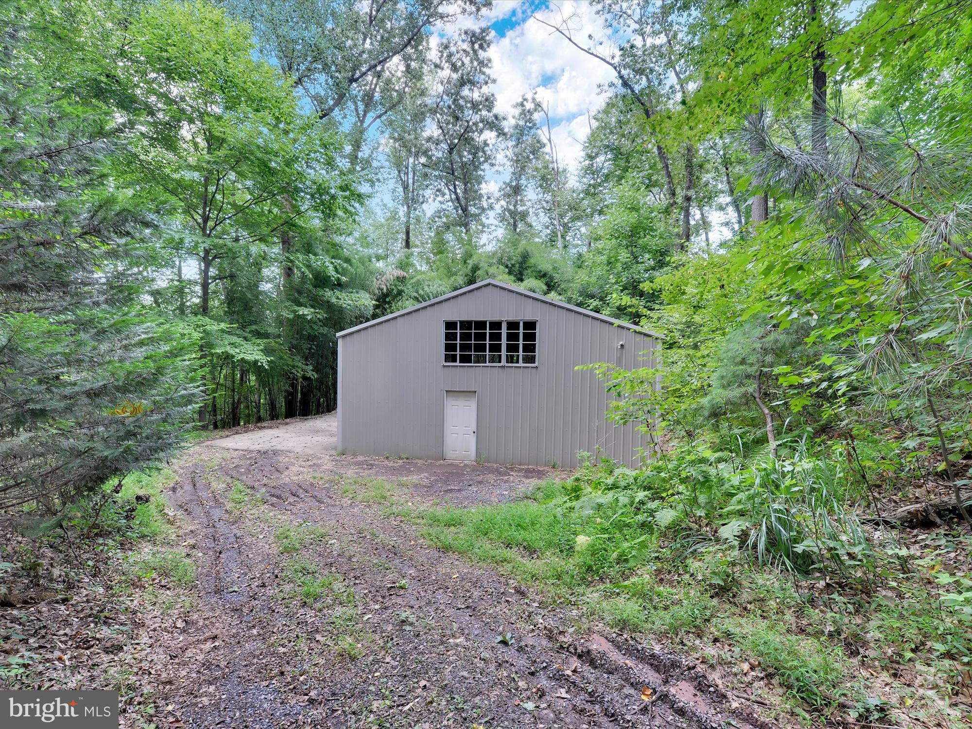 540 Hill Road Denver, PA 17517 - Photo 20 of 25 a view of a small house in a forest