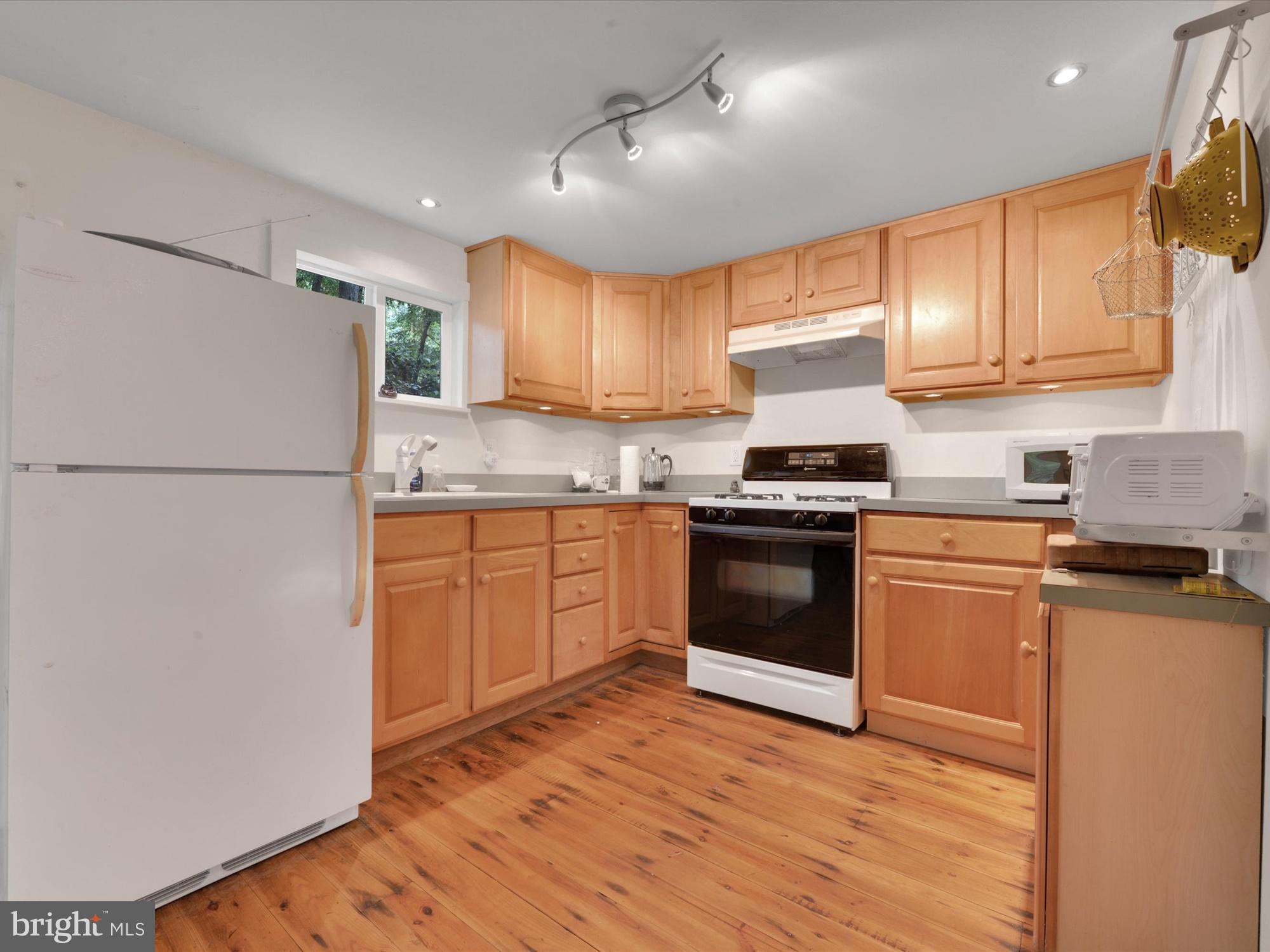 540 Hill Road Denver, PA 17517 - Photo 9 of 25 a kitchen with granite countertop a refrigerator stove top oven and sink