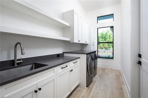 a kitchen with a sink and cabinets