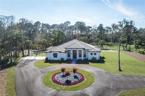 a view of a house with swimming pool and yard