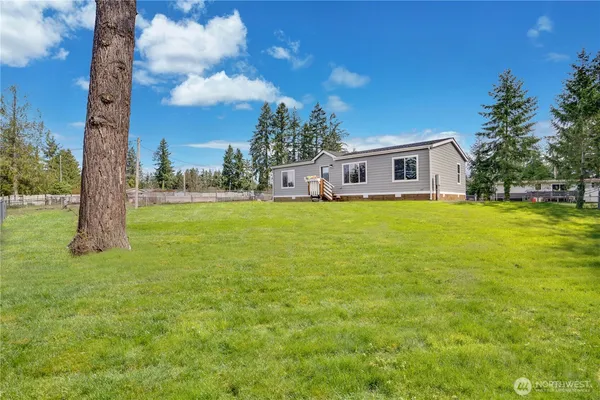 a view of a house with a tree in front of it