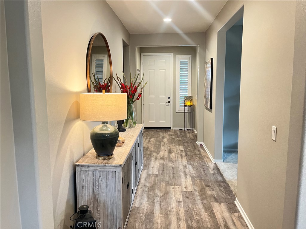 29653 Rigging Way Menifee, CA 92584 - Photo 3 of 11 a view of a bedroom with a bed and wooden floor