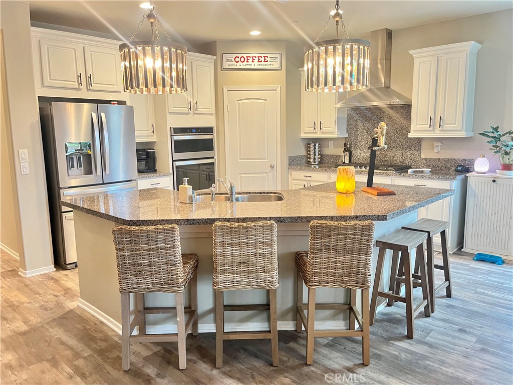 29653 Rigging Way Menifee, CA 92584 - Photo 5 of 11 a kitchen with stainless steel appliances granite countertop a sink and a refrigerator
