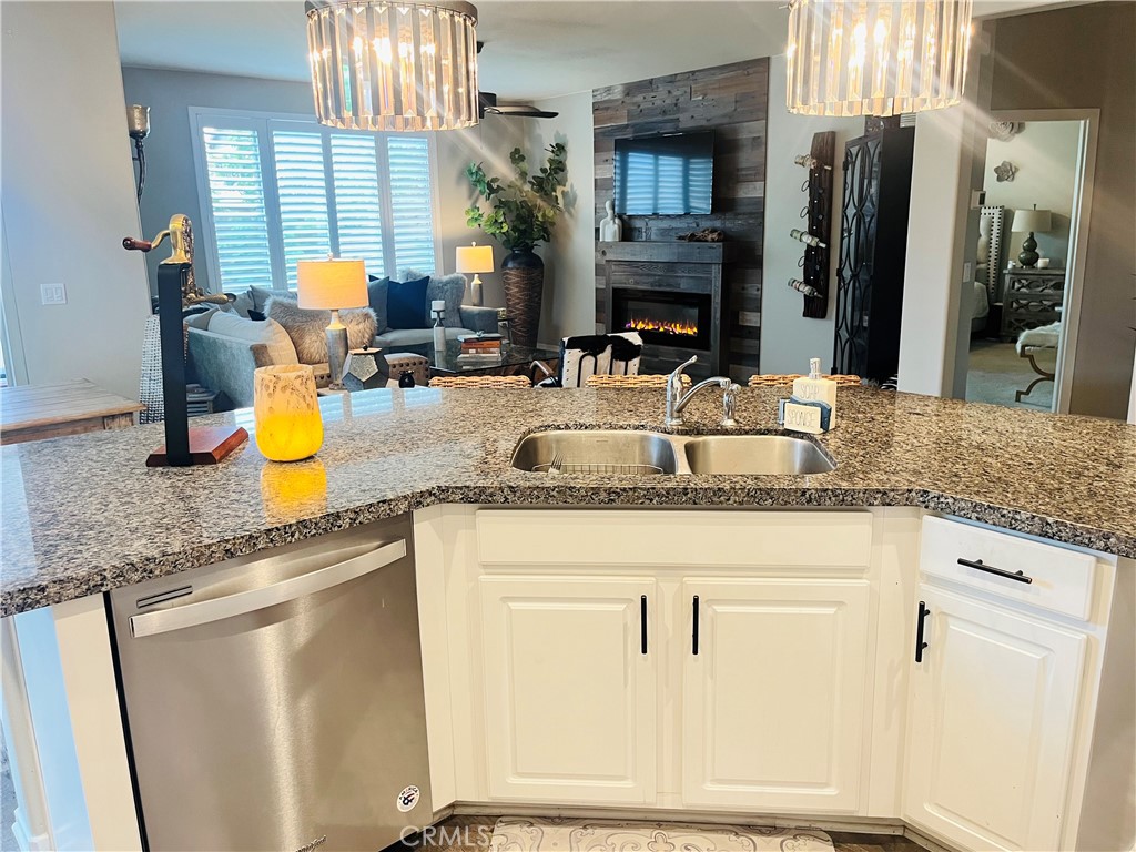 29653 Rigging Way Menifee, CA 92584 - Photo 6 of 11 a kitchen with kitchen island granite countertop a sink a counter top space and stainless steel appliances