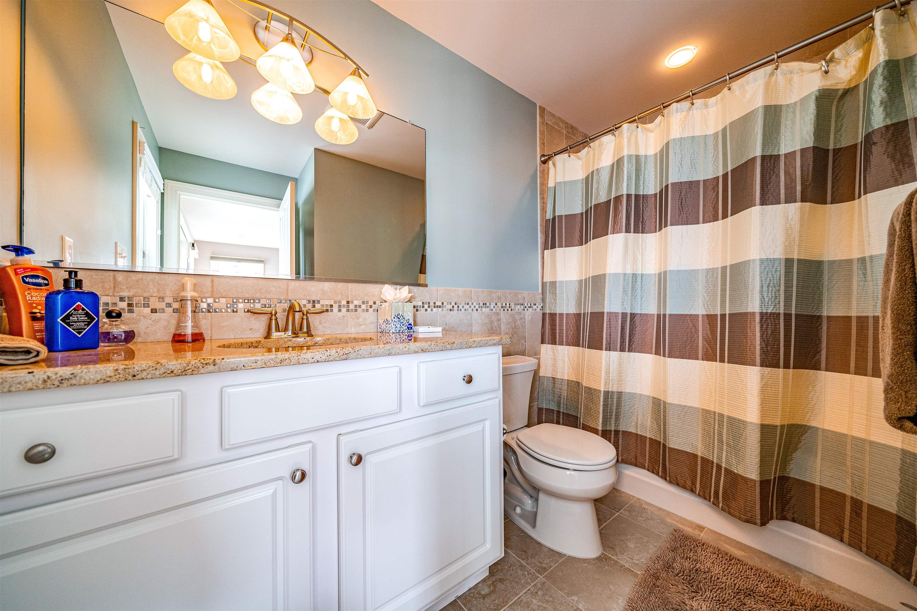 204 South Bayview, Unit SOUTH Strathmere, NJ 08248 - Photo 11 of 21 a bathroom with a sink a toilet a shower and a mirror