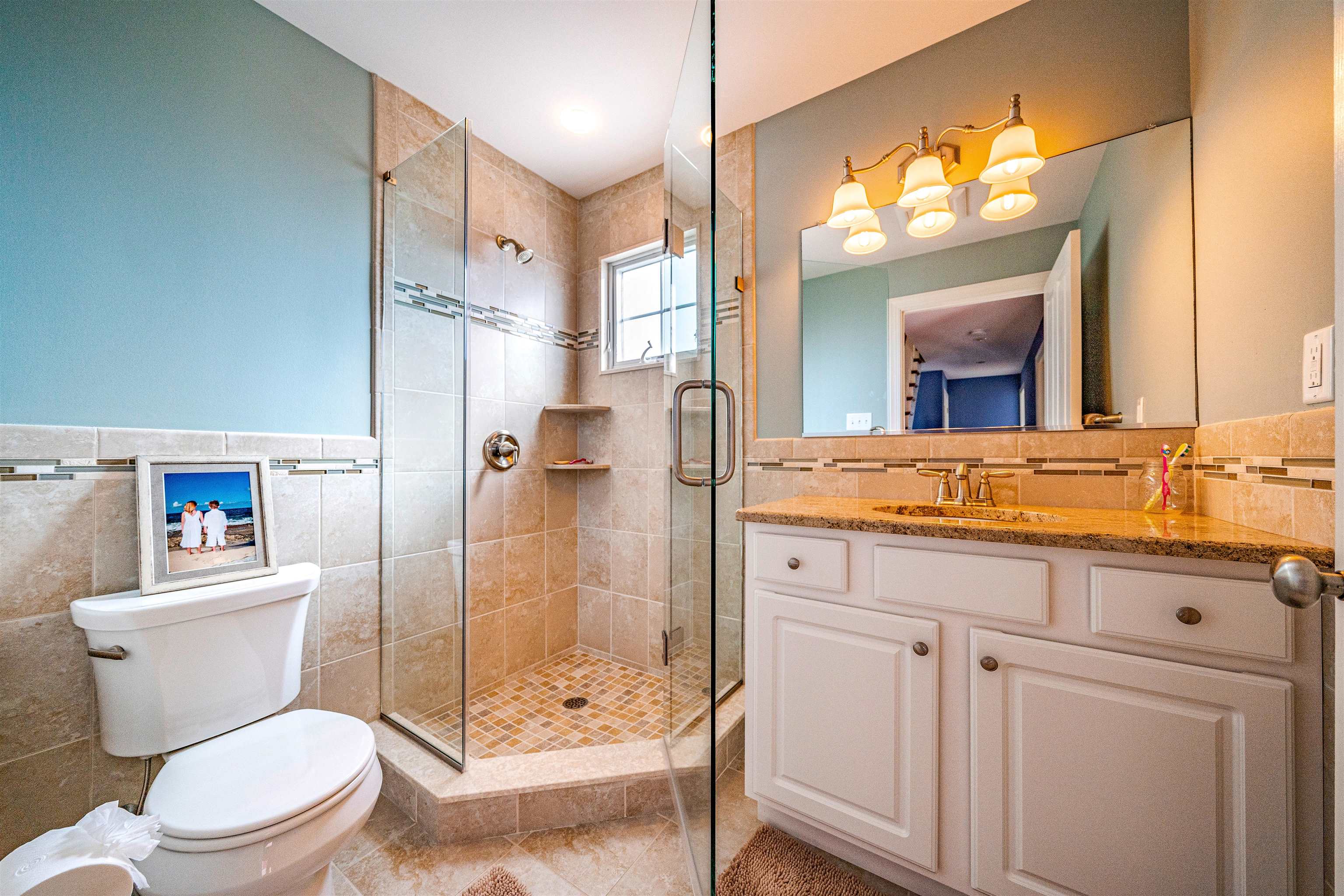 204 South Bayview, Unit SOUTH Strathmere, NJ 08248 - Photo 13 of 21 a bathroom with a sink a toilet a mirror and shower