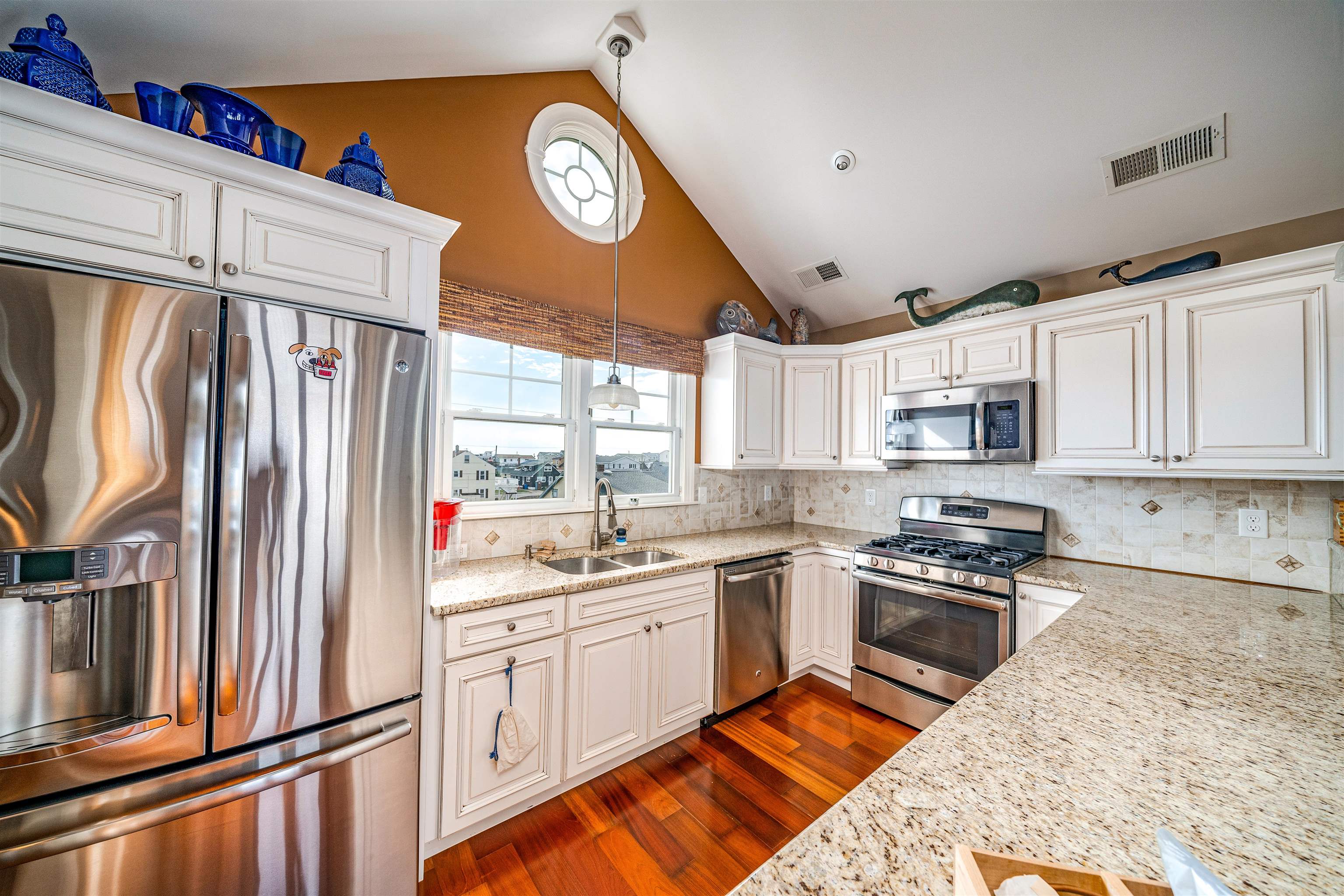 204 South Bayview, Unit SOUTH Strathmere, NJ 08248 - Photo 7 of 21 a kitchen with stainless steel appliances granite countertop a stove a sink and a refrigerator