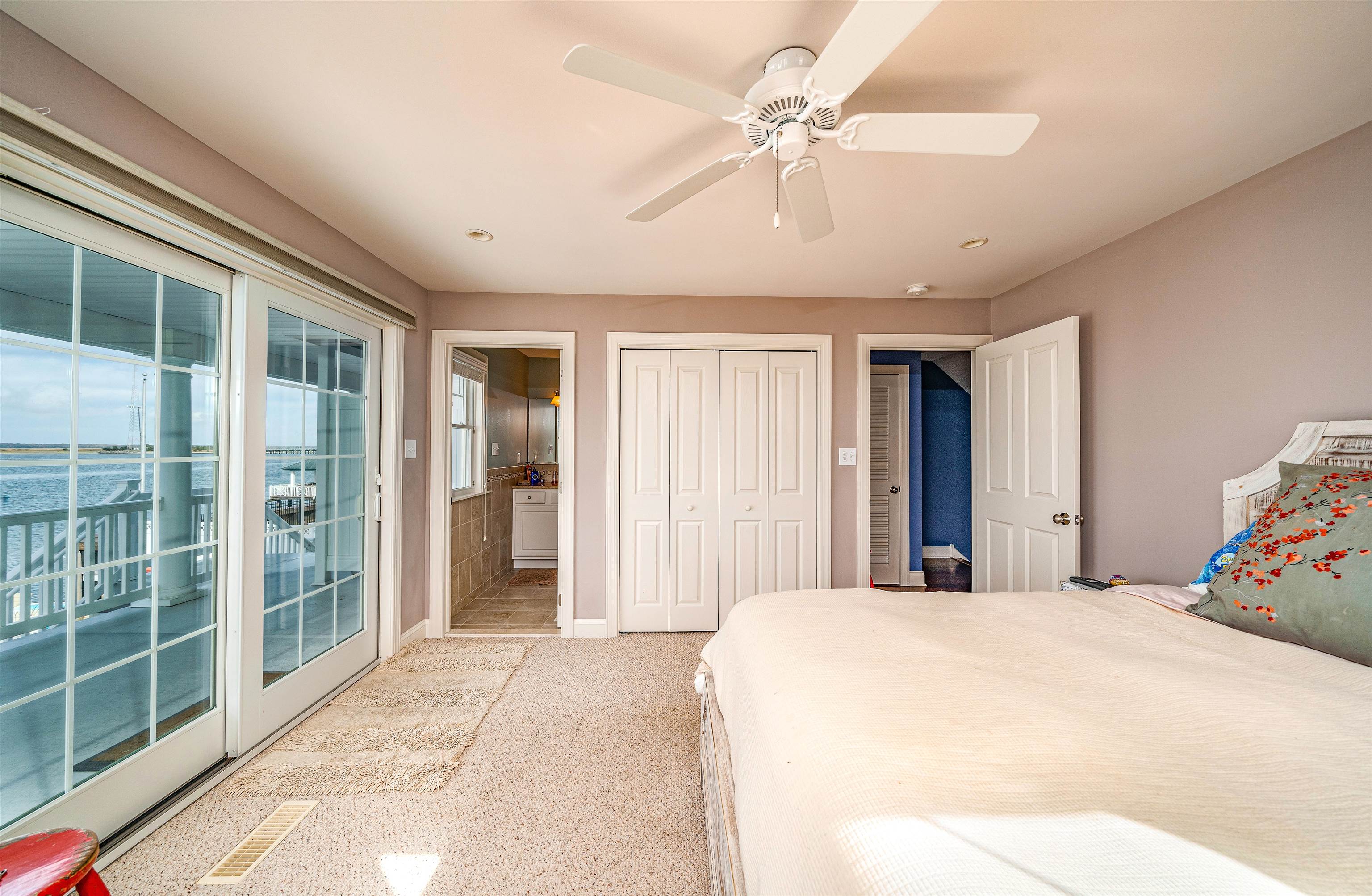 204 South Bayview, Unit SOUTH Strathmere, NJ 08248 - Photo 10 of 21 a spacious bedroom with a large bed and a chandelier