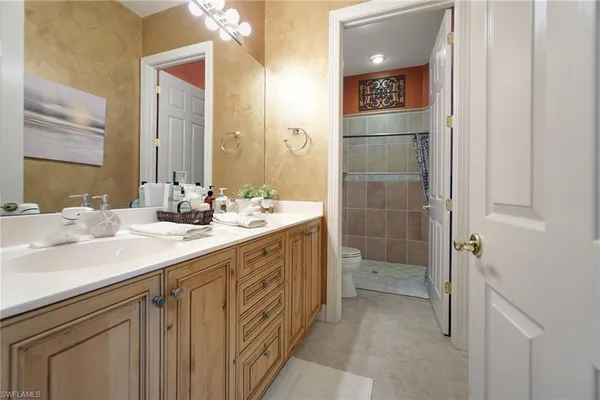 a bathroom with a double vanity sink a mirror and a shower