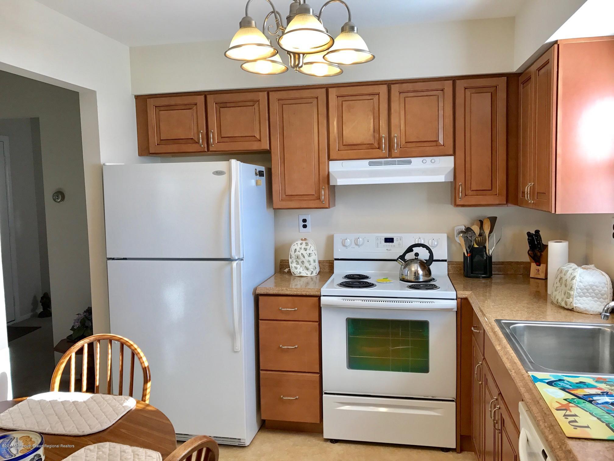 12 Dryden Road Brick, NJ 08724 - Photo 3 of 22 a kitchen with stainless steel appliances granite countertop a stove a refrigerator and a stove top oven