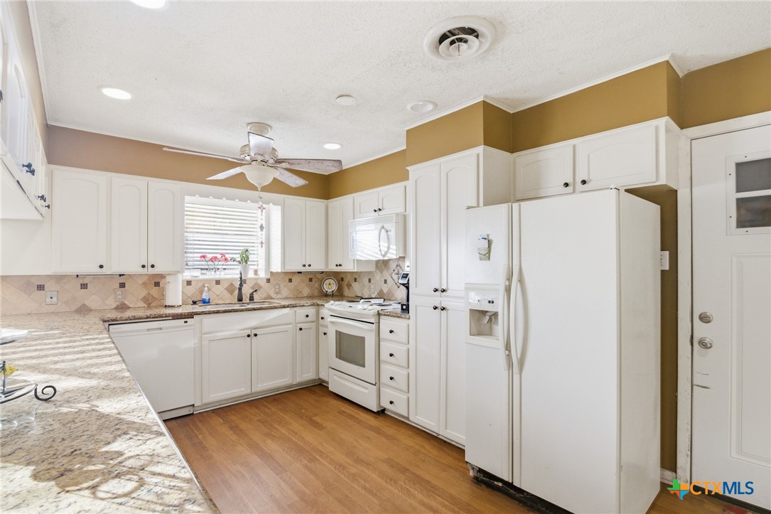 911 West Constitution Street Victoria, TX 77901 - Photo 15 of 42 a kitchen with stainless steel appliances a refrigerator sink and cabinets