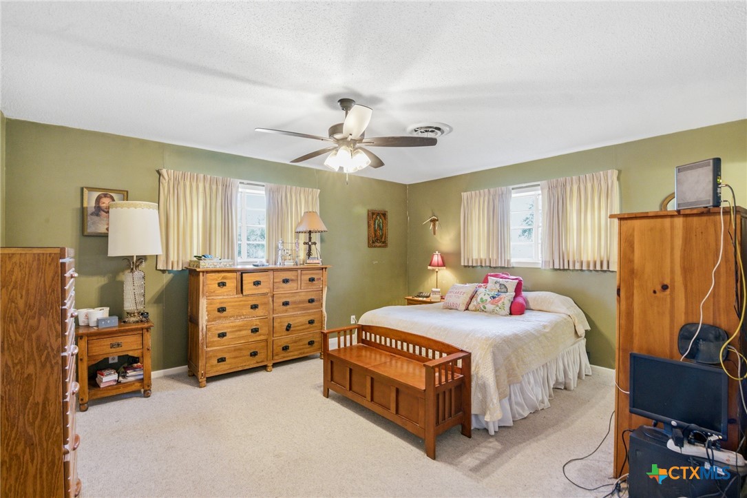 911 West Constitution Street Victoria, TX 77901 - Photo 28 of 42 a bedroom with a bed and a dresser