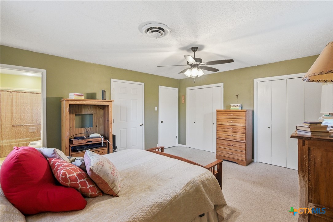 911 West Constitution Street Victoria, TX 77901 - Photo 29 of 42 a bedroom with a bed and a chandelier