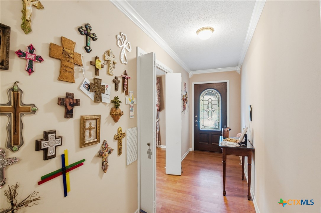 911 West Constitution Street Victoria, TX 77901 - Photo 7 of 42 a view of a hallway with wooden floor and a living room