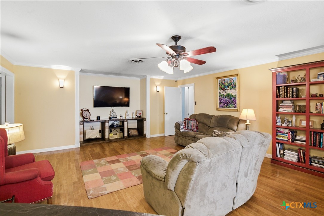 911 West Constitution Street Victoria, TX 77901 - Photo 9 of 42 a living room with furniture and a flat screen tv