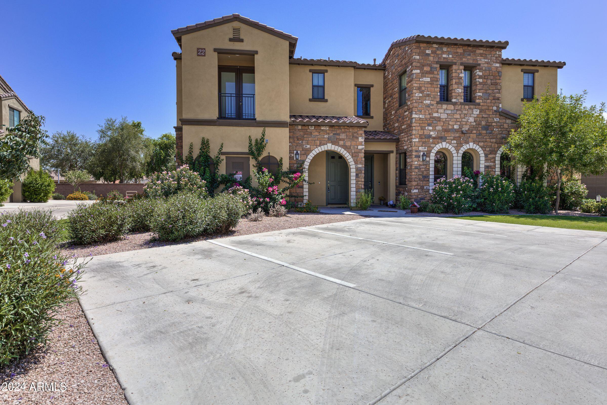 4777 South Fulton Ranch Boulevard, Unit 2066 Chandler, AZ 85248 - Photo 1 of 46 a front view of a building with garden
