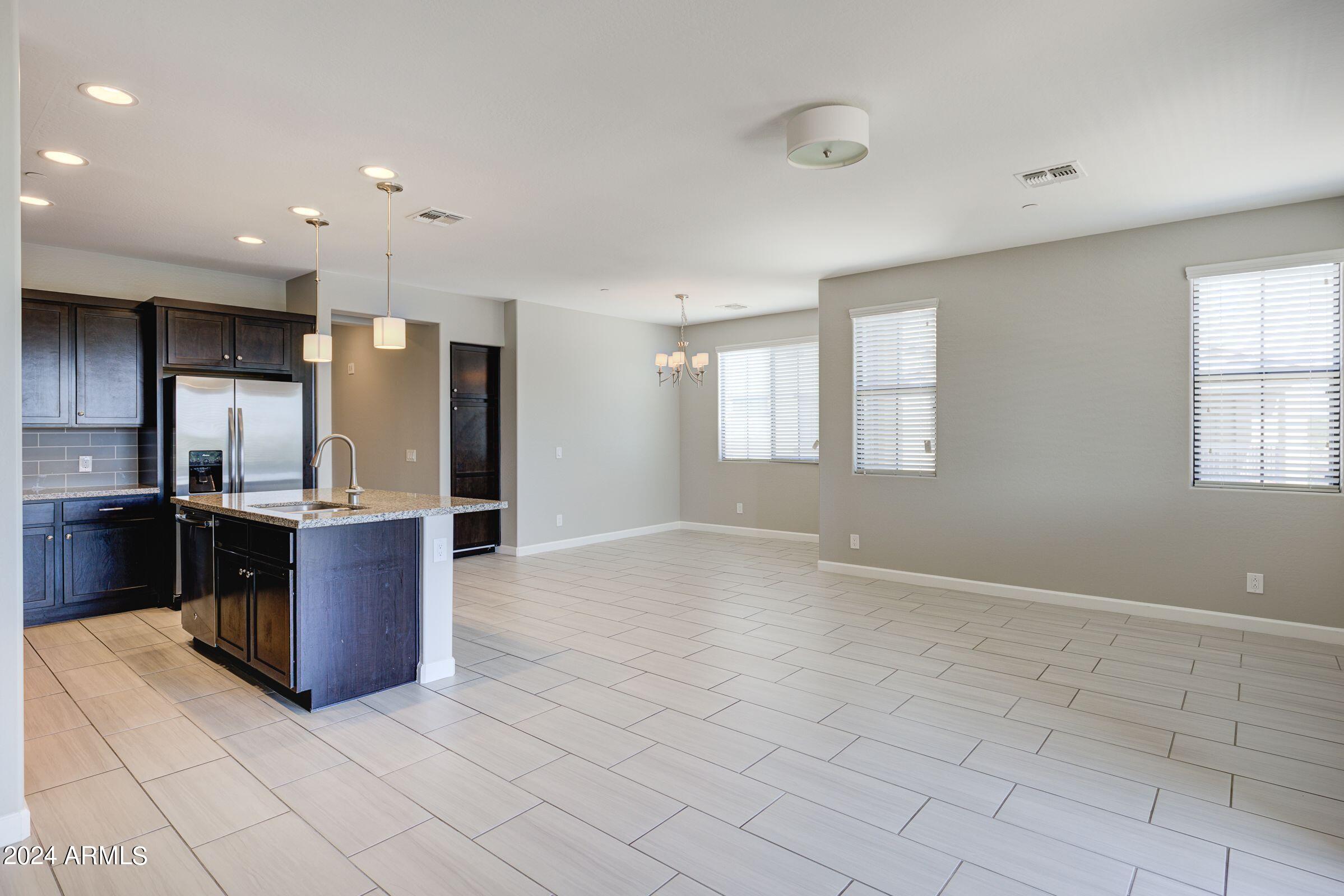 4777 South Fulton Ranch Boulevard, Unit 2066 Chandler, AZ 85248 - Photo 11 of 46 a large kitchen with stainless steel appliances granite countertop a refrigerator and a sink