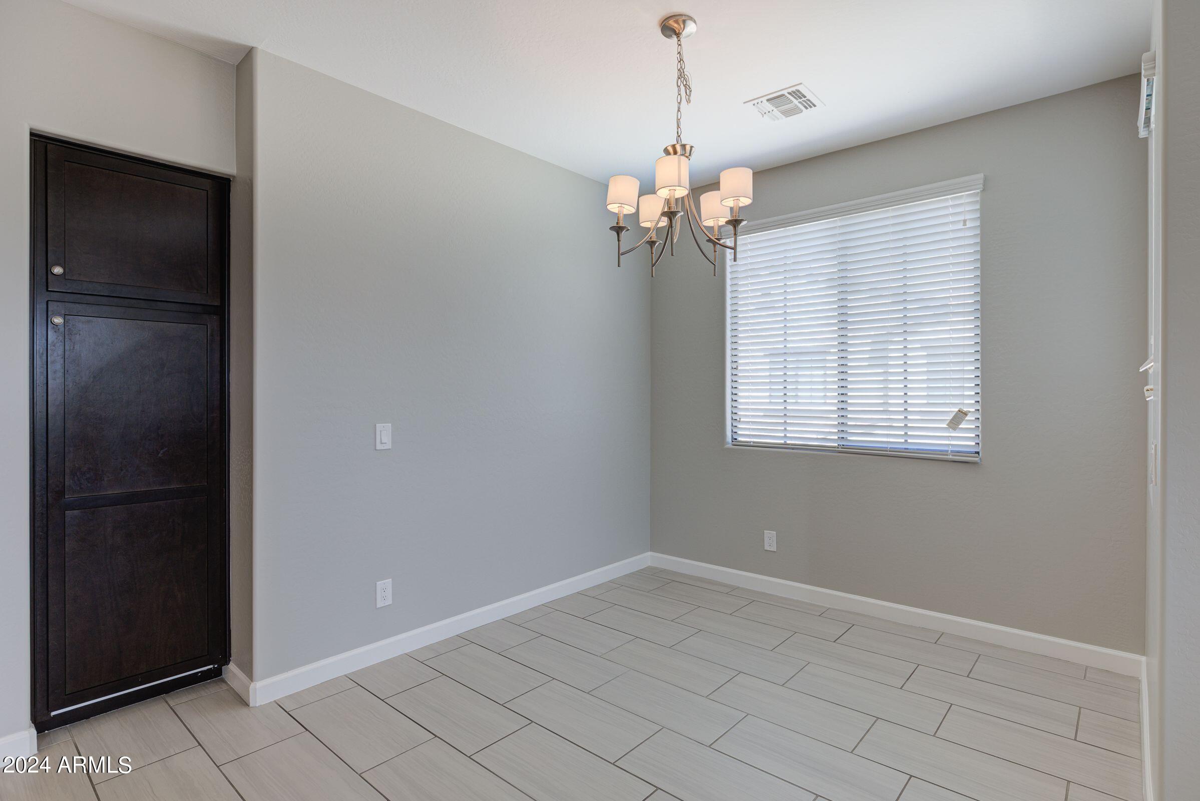 4777 South Fulton Ranch Boulevard, Unit 2066 Chandler, AZ 85248 - Photo 12 of 46 wooden floor in an empty room with a window